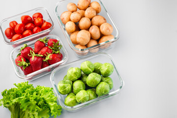 Glass boxes with fresh raw vegetables.  Vegetables and fruits in glass containers. Food storage concept