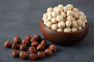  A bowl full of hazelnuts on dark background