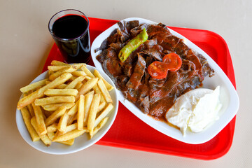 Turkish and Arabic Traditional Ramadan doner kebab with tasty tomato sauce and rice or turkish...