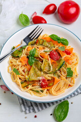 Linguine pasta with vegetables in tomato sauce.