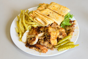 Turkish and Arabic Traditional Ramadan chicken doner kebab with tasty tomato sauce and rice or...