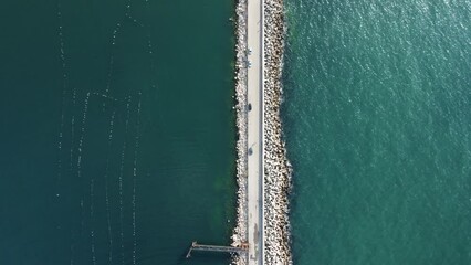 Aerial drone view of a breakwater. Tetrapod pier along the shore, Sea waves breaking on tetrapod pier drone view Breakwater in the sea, a collection of concrete breakers. sea pier.
