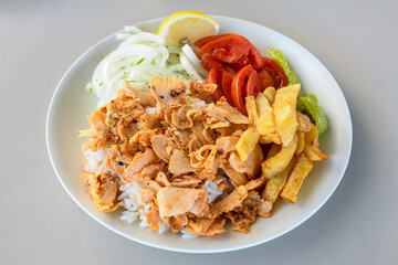 Turkish and Arabic Traditional Ramadan chicken doner kebab with tasty tomato sauce and rice or...
