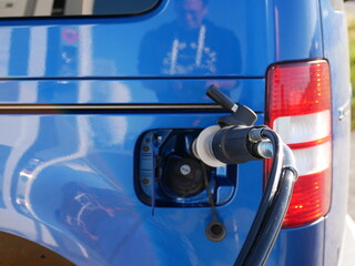 Compressed natural gas (CNG) vehicle fuel nozzle connected to car