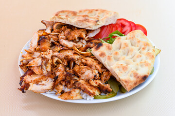 Turkish and Arabic Traditional Ramadan chicken doner kebab with tasty tomato sauce and rice or...