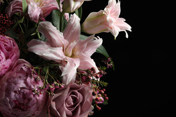 Beautiful bouquet of different flowers on dark background, closeup