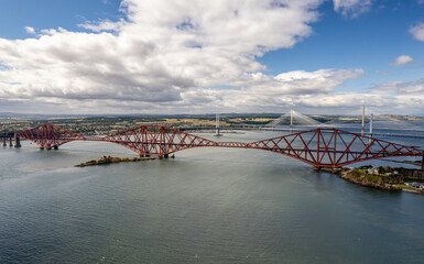 The drone aerial view of the Forth Bridges and the new Queensferry Crossing. The Forth Bridge is a cantilever railway bridge across the Firth of Forth in the east of Scotland.