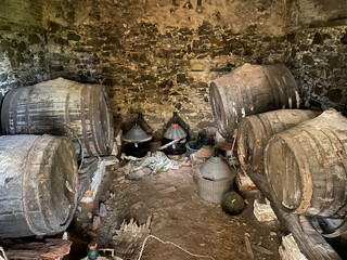 old, dilapidated winery with old barrels and bottles, lost place
