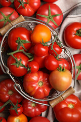 Many different ripe tomatoes on table, flat lay