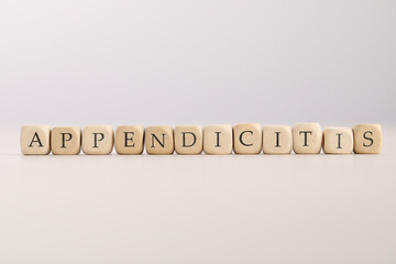 Word Appendicitis made of wooden cubes with letters on light background