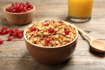 Muesli with berries served on wooden table. Delicious breakfast