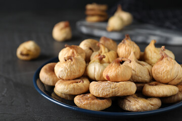 Tasty dried figs on grey table, closeup