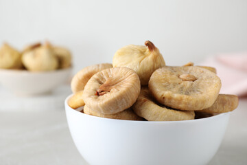 Tasty dried figs on light grey table, closeup