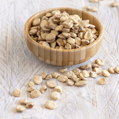 Bowl of raw dry Grass pea close up on wooden table. Legumes known in Italy as Cicerchia