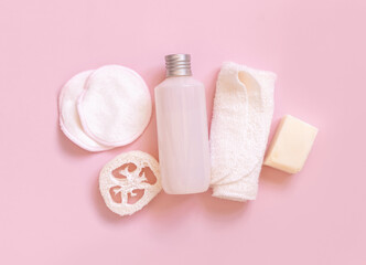 Fototapeta na wymiar Cosmetic bottle and eco-friendly skin care accessories on pink, mockup