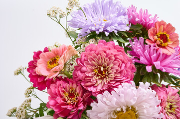 A bouquet of bright flowers on a light background.