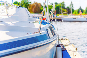 The part of the yacht with the blue lake water at summer day.