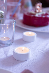 Fototapeta na wymiar Candles in plaster candlesticks, minimalistic decor, selective focus
