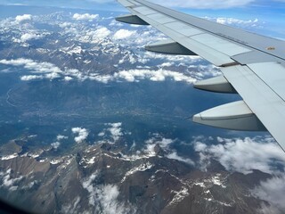 Obraz premium Wing of plane over mountain cover with some snow