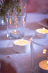 Obraz na płótnie Canvas Candles in plaster candlesticks, minimalistic decor, selective focus