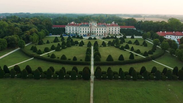 Fertod, Hungary - 4K Aerial view of Eszterhazy Palace near Sopron. Flying over Eszterhazy castle and garden on a bright summer morning at sunrise