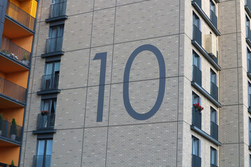House number ten. Large number 10 on the wall of the building.  