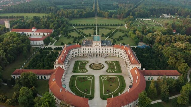 Fertod, Hungary - 4K Aerial view of Eszterhazy Palace near Sopron. Flying over Eszterhazy castle and garden on a bright summer morning at sunrise