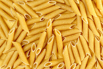Whole grain penne pasta from durum wheat. Top view. Texture