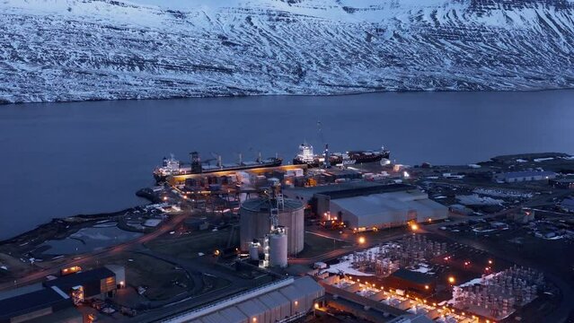 Boats anchored at port delivering aluminium metal to smelter facility, Iceland