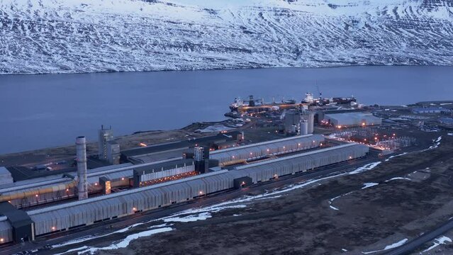 Large industrial building in Iceland fjord early morning, aerial