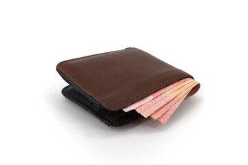 Leather wallet with banknotes inside isolated on white background.