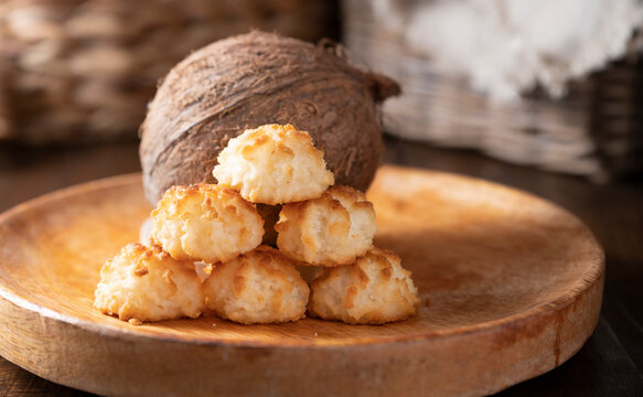 Coconut cookies. Homemade gluten free pastry with coconut. Small round sweets on a wooden table. High quality photo. Copy space