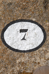 Number Seven on Stone Wall