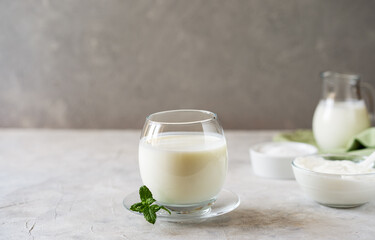 Ayran is a popular refreshing Middle Eastern beverage made with yogurt, water and salt. Concrete background