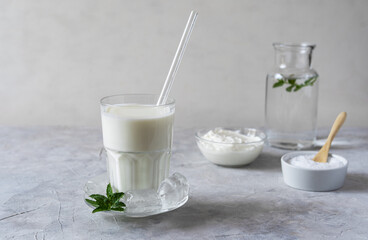 Ayran is a popular refreshing Middle Eastern beverage made with yogurt, water and salt. Concrete background