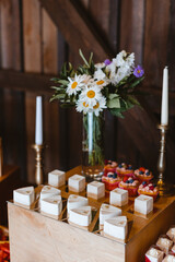 Candy bar. Festively decorated buffet table for guests. A stand with a variety of desserts for celebrating a party. Sweet buffet at a wedding party, birthday party.