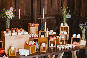 Candy bar. Festively decorated buffet table for guests. A stand with a variety of desserts for celebrating a party. Sweet buffet at a wedding party, birthday party.