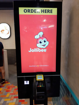 "Sunway, Malaysia- Circa June, 2022: Selective focus picture with noise effect of Jollibee Fast Food Restaurant touchscreen Smart Kiosk. Photo taken using smartphone."