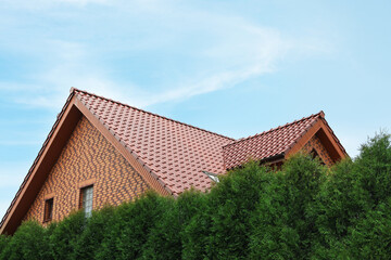 Beautiful house with red roof against blue sky