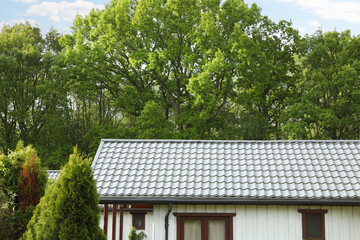 Modern building with grey roof outdoors on spring day