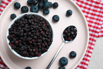 Freeze dried and fresh blueberries on table, top view