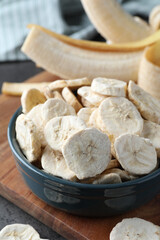 Freeze dried and fresh bananas on table, closeup