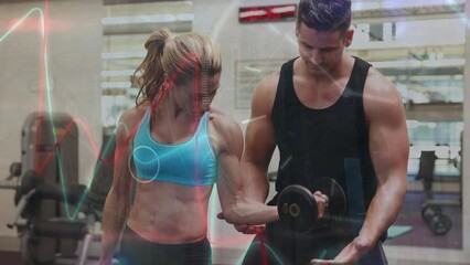 Animation of interface processing data over caucasian woman and male fitness trainer in gym - Powered by Adobe