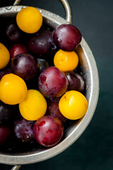Plums on the dark background