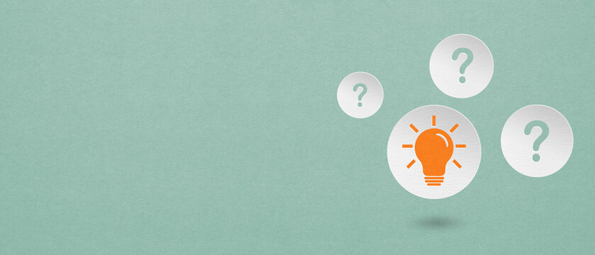 For idea, innovation, brainstorming concept. Bright orange light bulb on circle white paper cut with question mark and grunge green background including copy space