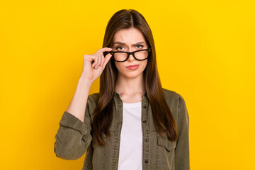 Photo of clever serious businesswoman look at you with judging expression isolated on yellow color background - obrazy, fototapety, plakaty