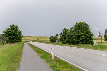 Fototapeta na wymiar coastal road with cycle lane at Oresund green shore, near Niva, Denmark