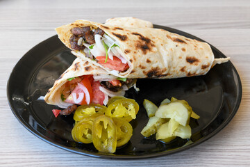 Lavash doner kebab ( doner zurna durum )  or shawarma sliced in plate isolated. 