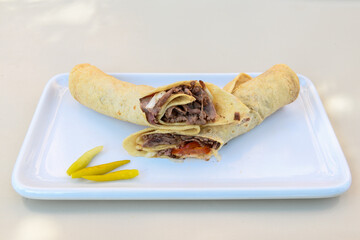 Lavash doner kebab ( doner zurna durum )  or shawarma sliced in plate isolated. 