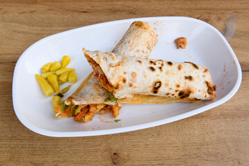 Lavash doner kebab ( doner zurna durum )  or shawarma sliced in plate isolated. 